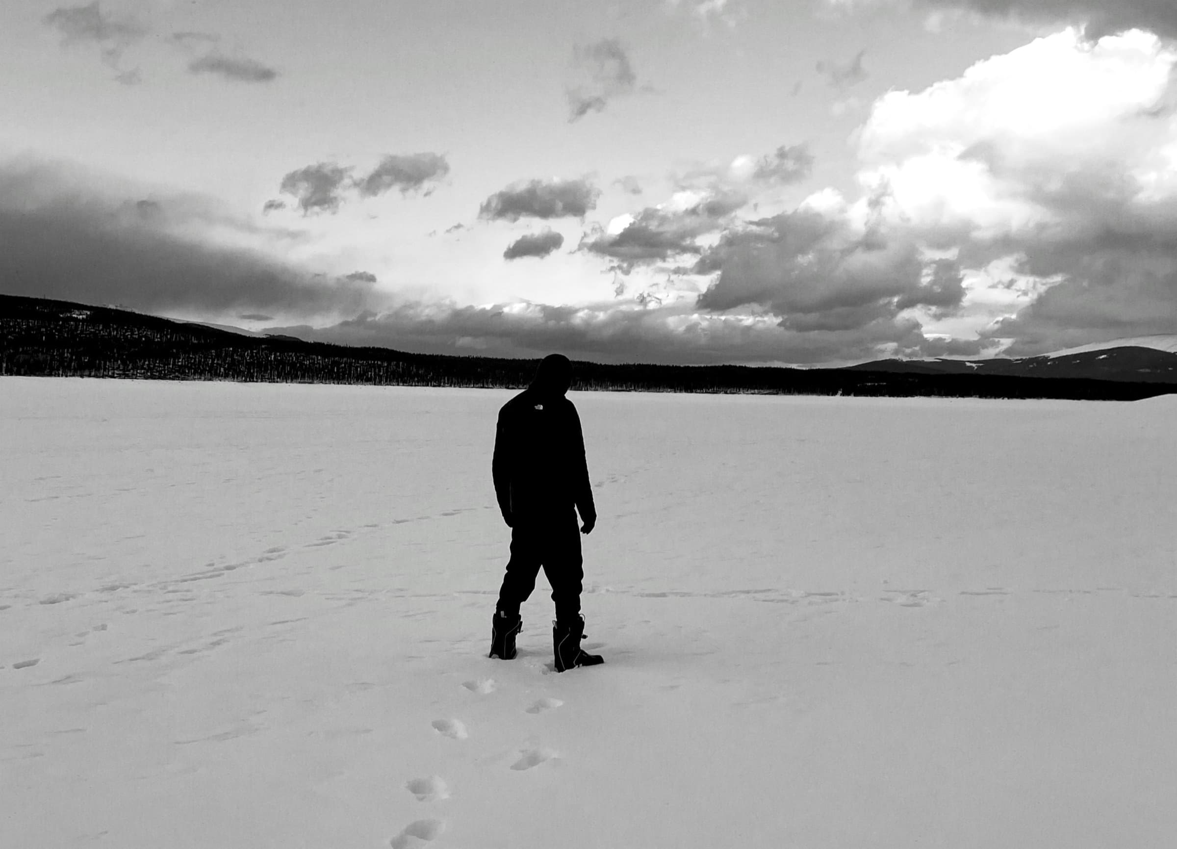 Lone figure walking across a frozen lake near Toronto
